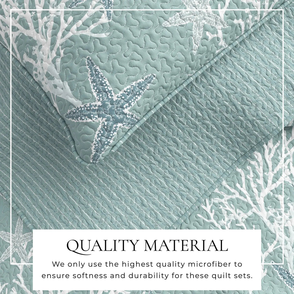 Blue coral quilt set with matching shams styled on a wood bed frame in an ocean-inspired room