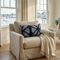 Blue embroidered 14 x 24 lumbar throw pillow styled on a neutral coastal sofa