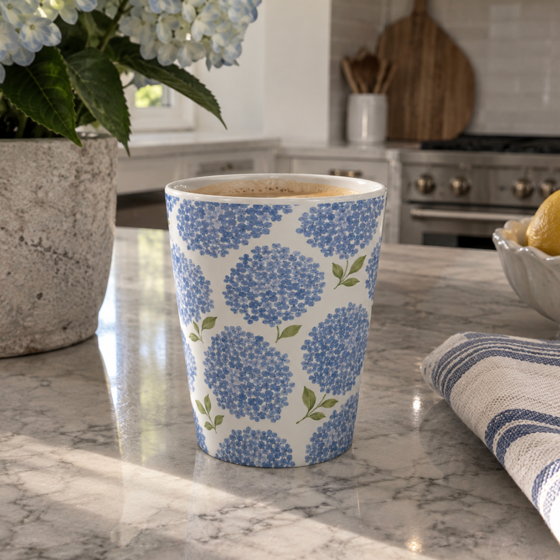 Blue floral coastal kitchen mug with hydrangea blossoms on a soft aqua background