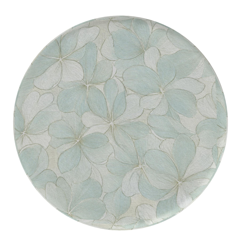 Blue and ivory botanical-print round footstools providing flexible seating in a relaxed coastal interior.