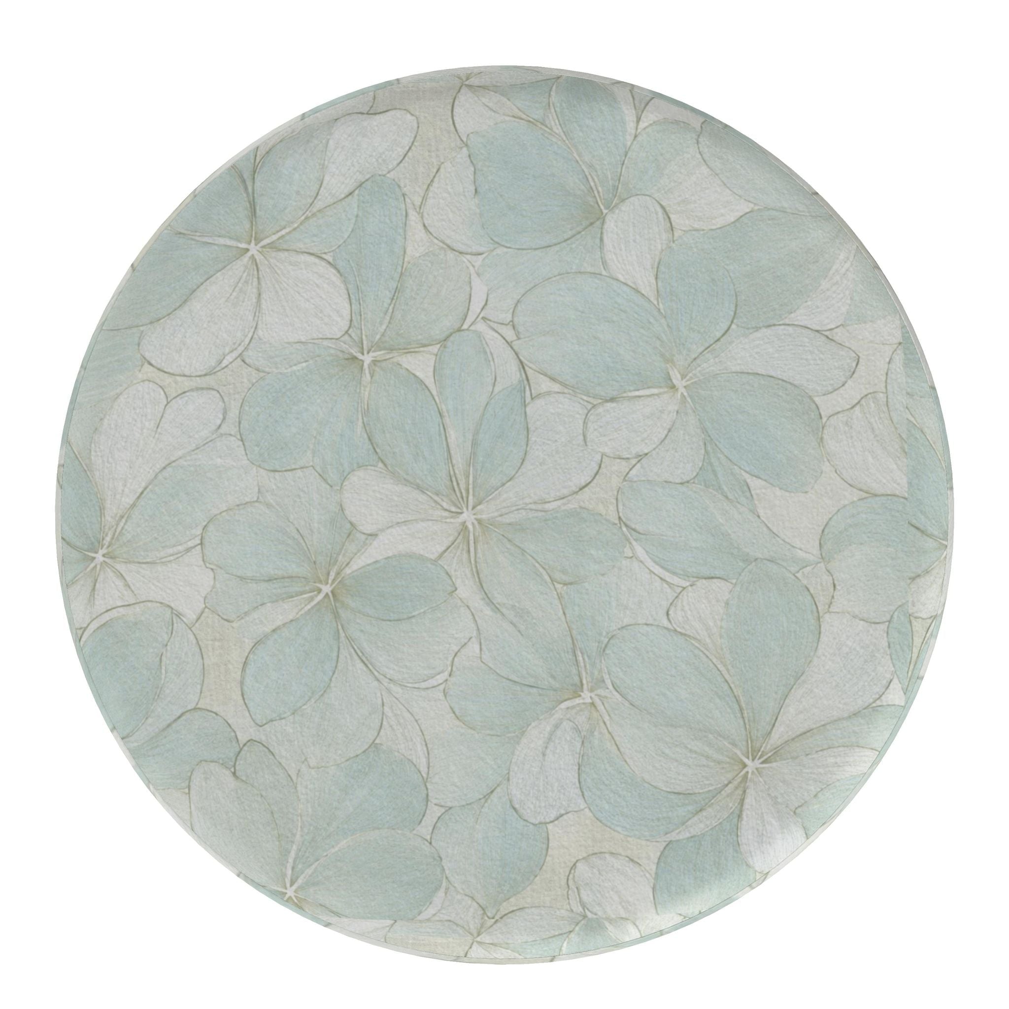 Blue and ivory botanical-print round footstools providing flexible seating in a relaxed coastal interior.