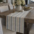 Blue-gray and ivory striped coastal table runner with tailored vertical stripes for a beach house dining table