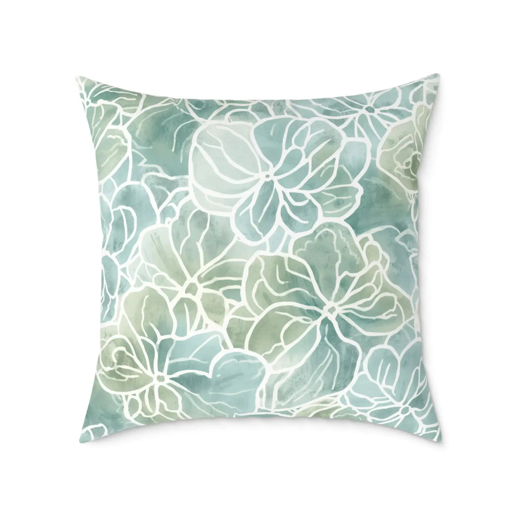 Blue green coastal flora decorative pillow bringing a soft seaside look to a modern living room.