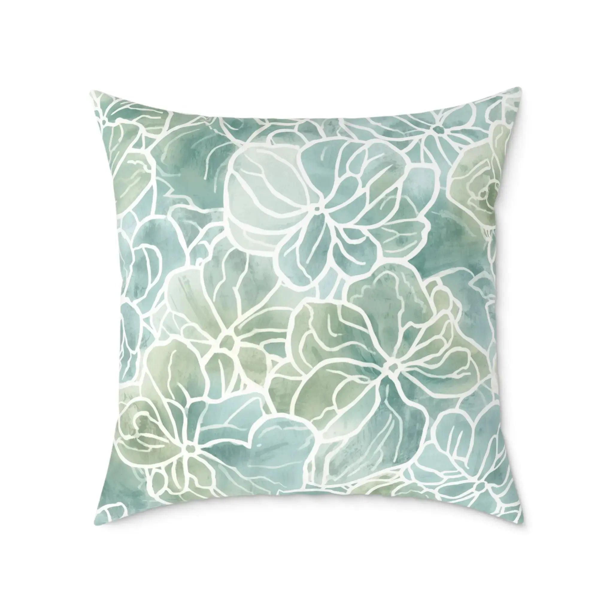 Blue green coastal flora decorative pillow bringing a soft seaside look to a modern living room.
