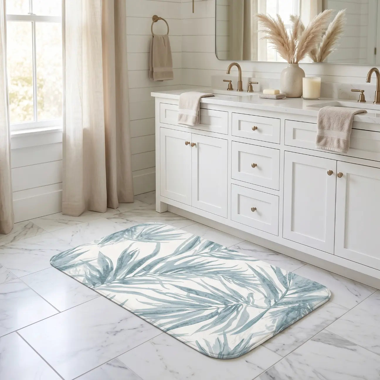 Blue palm leaf bath mat placed in front of a shower in a beach house.