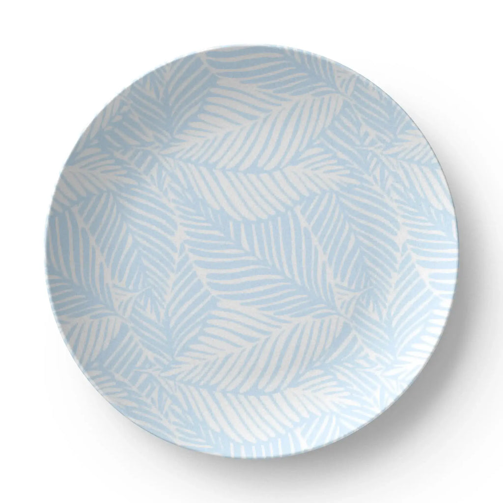 Closeup of blue palm tree pattern on coastal dinner plate.