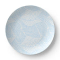 Closeup of blue palm tree pattern on coastal dinner plate.