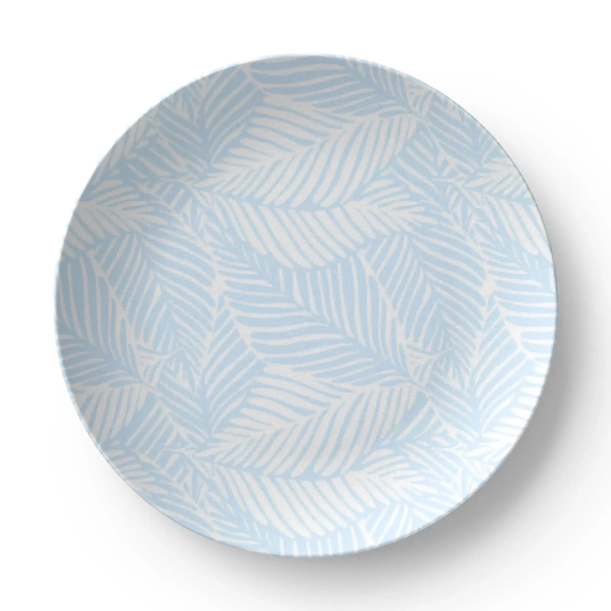 Closeup of blue palm tree pattern on coastal dinner plate.
