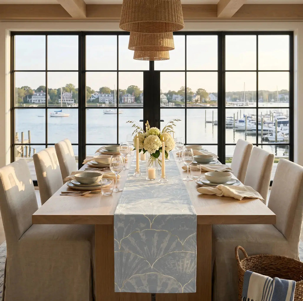 Blue seashell pattern table runner styled with white dishes and shell accent
