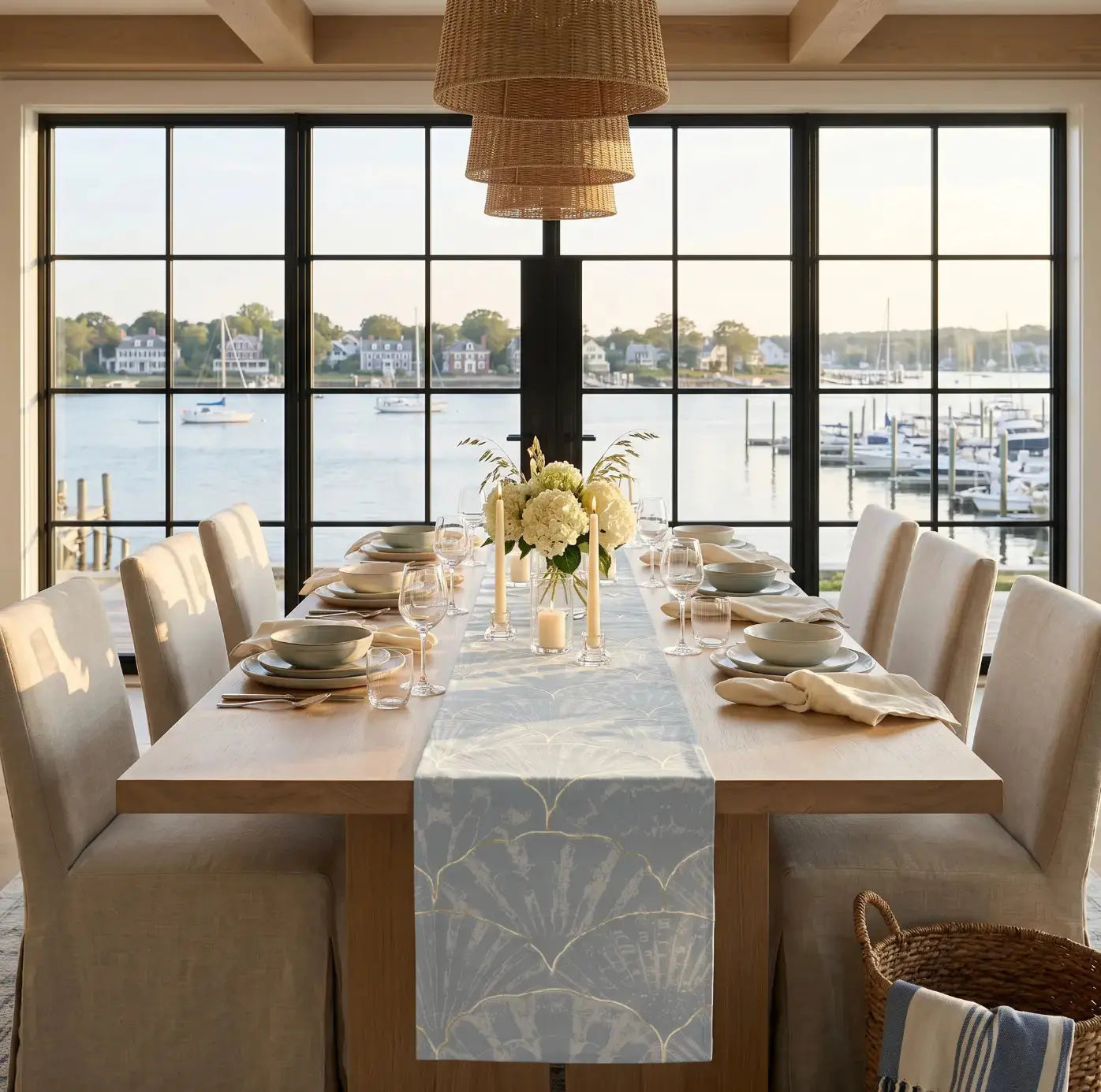 Blue seashell pattern table runner styled with white dishes and shell accent
