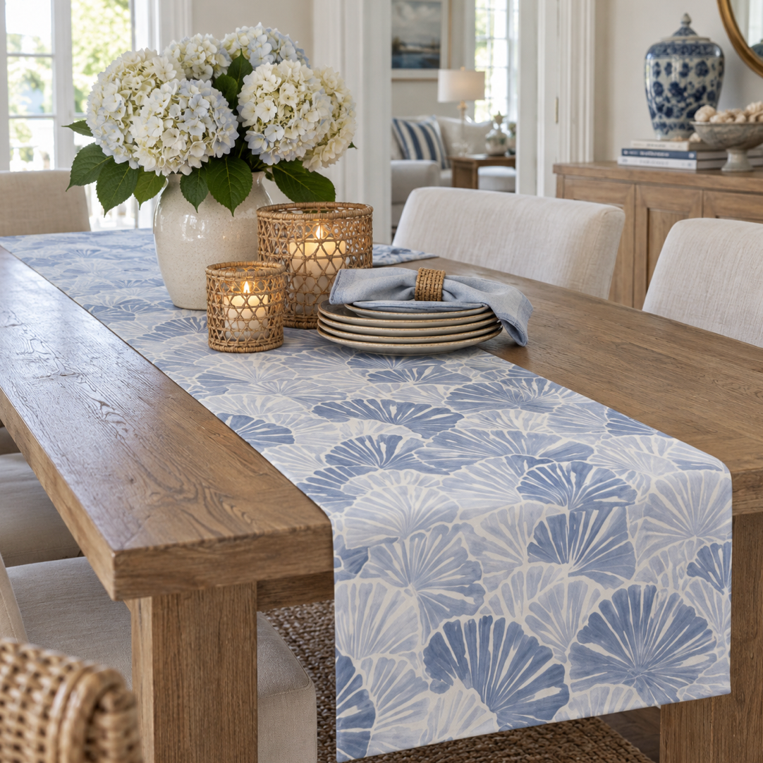 Blue shell beach house table linens with layered fan shells for everyday coastal entertaining