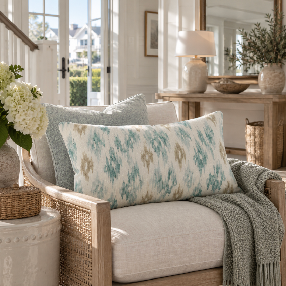 Blue and tan ikat rectangular throw pillow styled with neutral coastal cushions