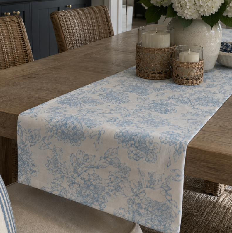 Blue toile coastal dining table runner with soft floral branches and an ivory background