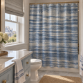 Blue washed stripe shower curtain for a relaxed coastal bathroom