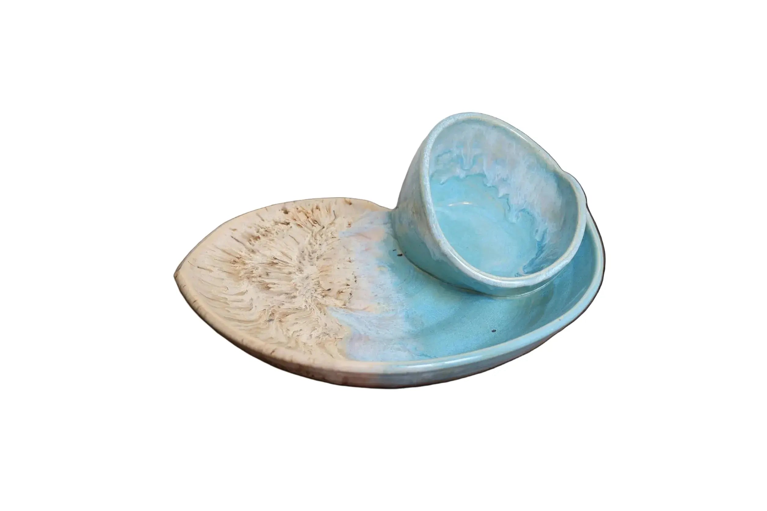 Handmade coastal swirly serving bowls with turquoise glaze and sandy beige marbling, stacked for display.