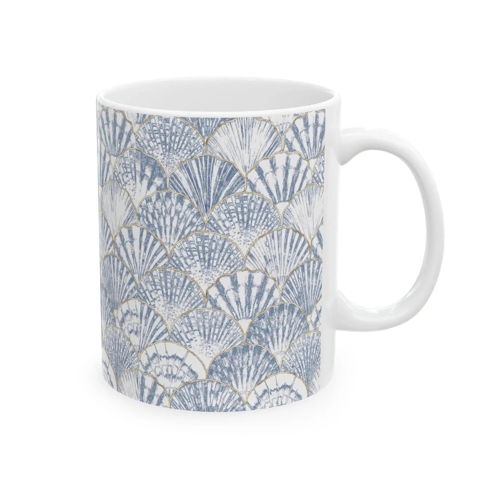 Closeup of blue seashell pattern on white ceramic coffee mug