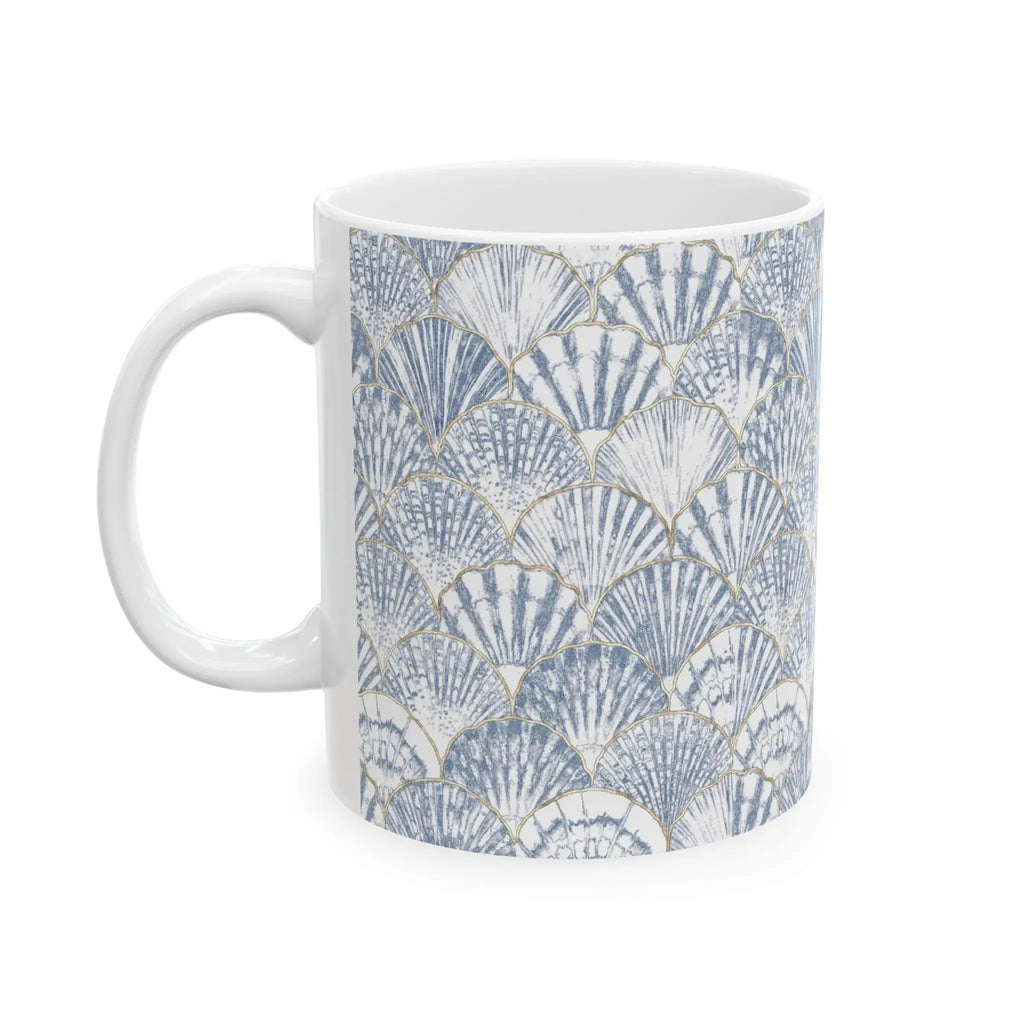 Side view of blue seashell coffee mug with curved handle