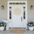 Round white and yellow pampas grass wreath with soft, flowing plume on front door