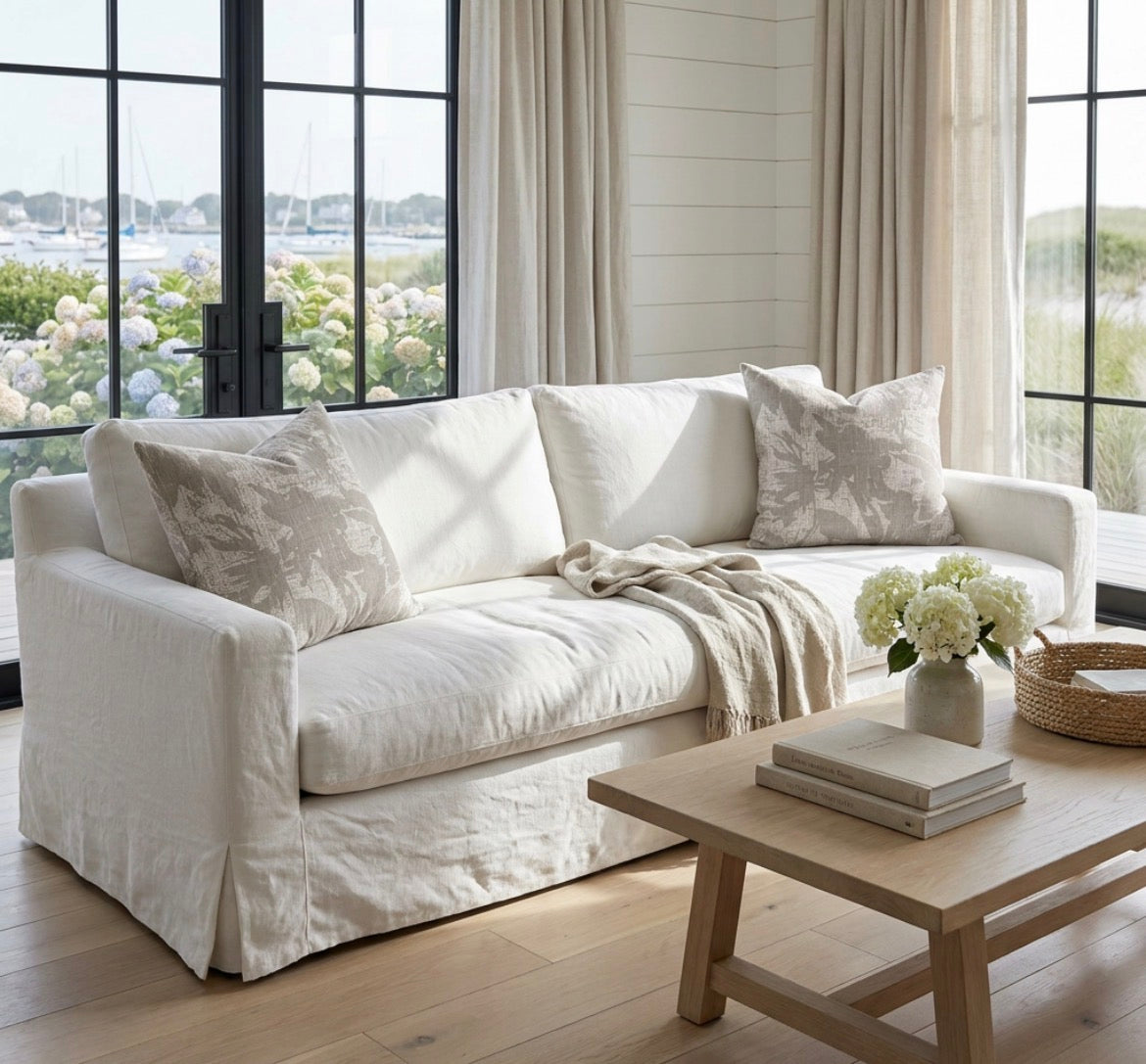 neutral brown linen texture throw pillow on a cream sofa in a cozy living room.