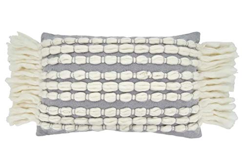 Cream loop and grey lumbar pillow bringing relaxed coastal warmth to a bright beach‑inspired seating area.