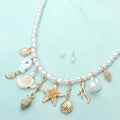 Starfish shell fish charm station beaded pearl coastal necklace shown as beach inspired jewelry