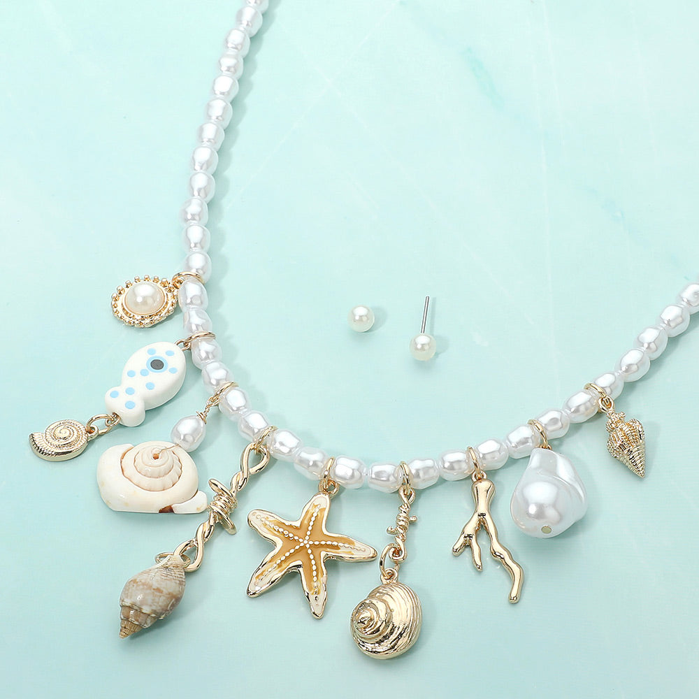 Starfish shell fish charm station beaded pearl coastal necklace shown as beach inspired jewelry