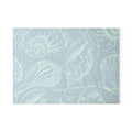 Tempered glass cutting board in seafoam tones with white seashell outlines.