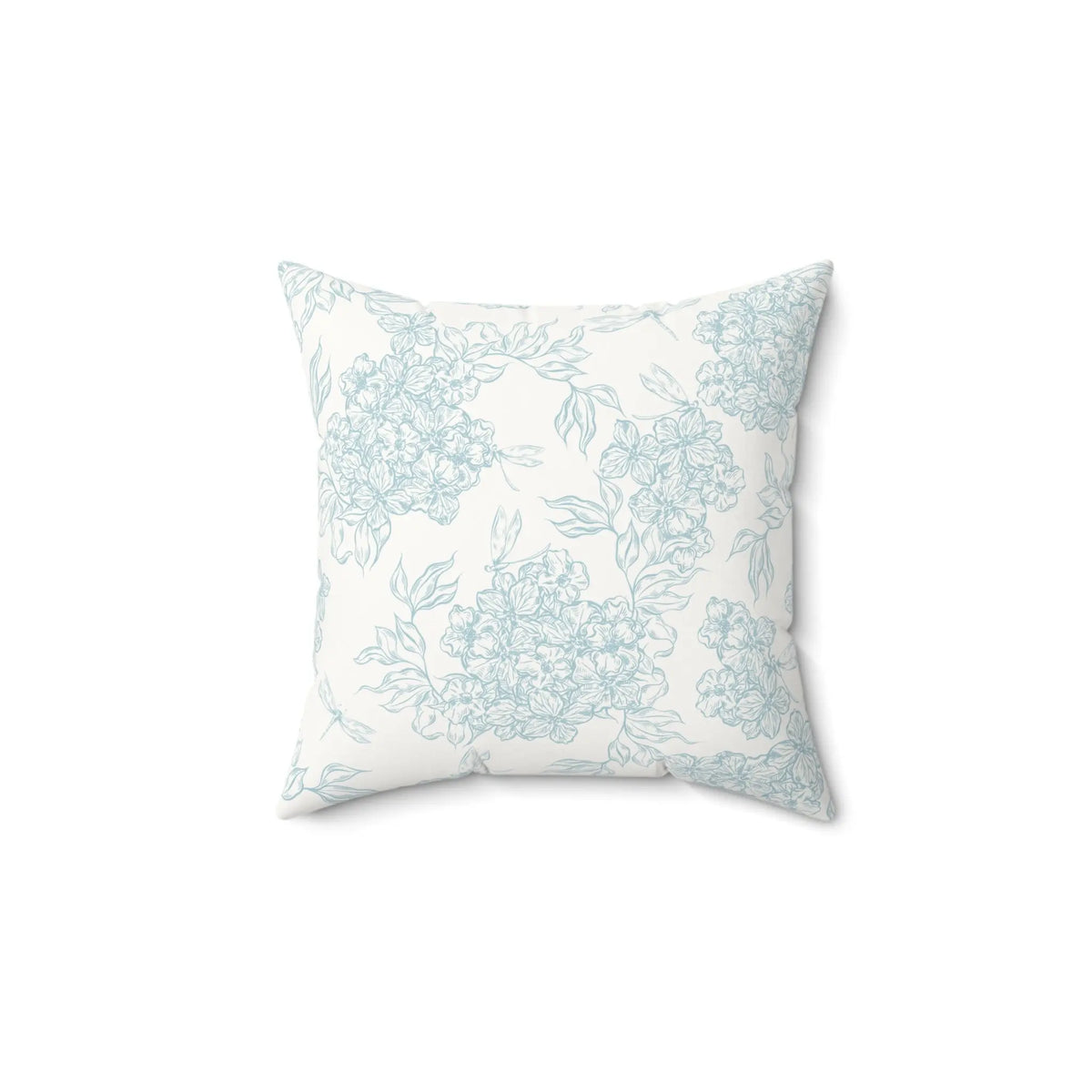 Coastal blue floral throw pillow styled on a neutral sofa