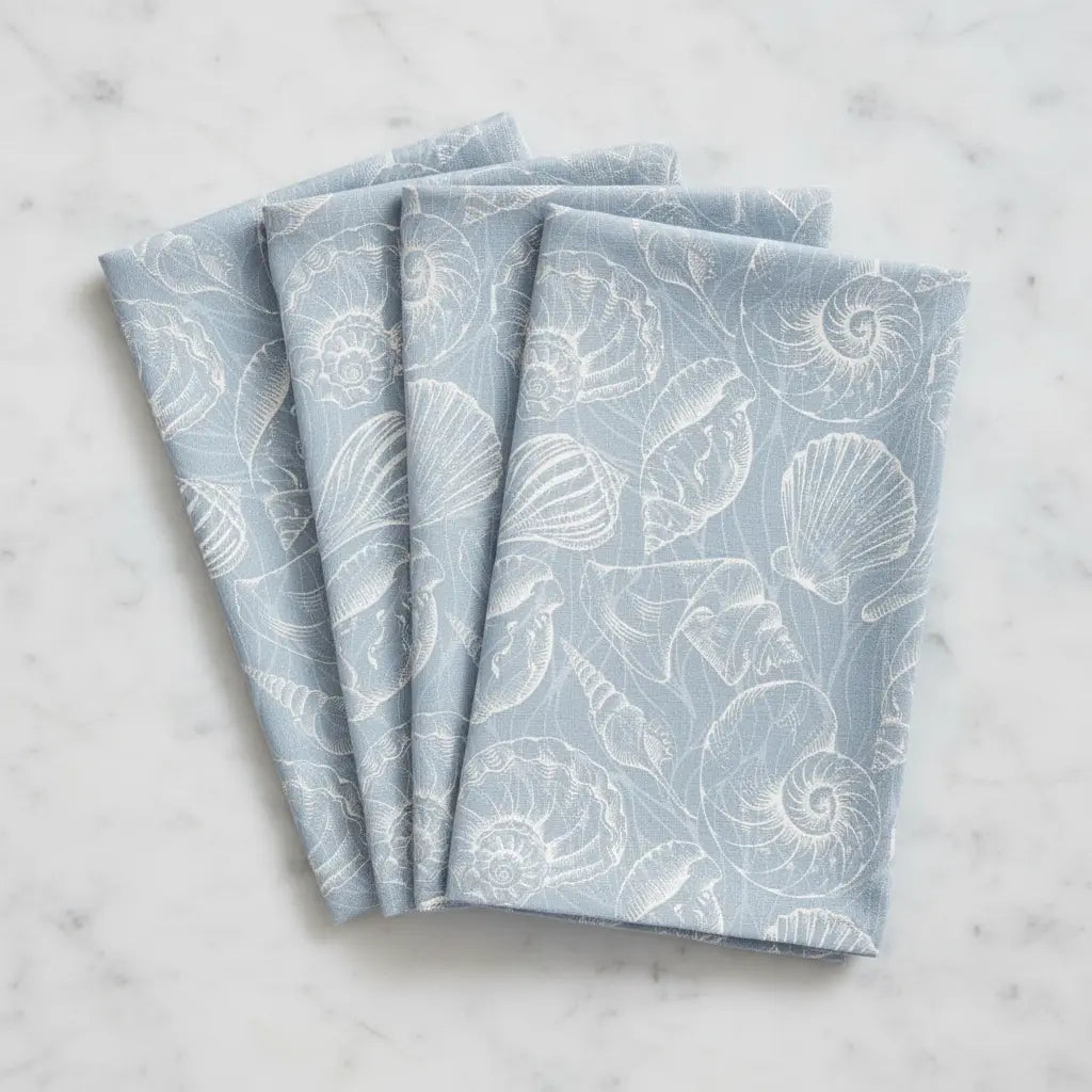 Coastal Blue Seashell Linen Napkins (Set of 4) with white seashell print on blue fabric.