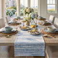 Coastal blue washed stripe table runner on a natural wood dining table with neutral place settings