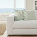 Islamorada Coral Double-Sided Throw Pillow on a white sofa, seafoam with coral-patterned front and back.