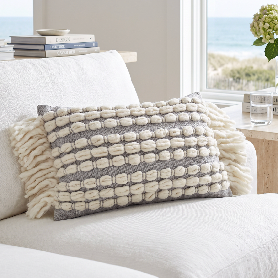 Beach house lumbar cushion featuring chunky cream loop stripes on a soft grey base for airy coastal decor.