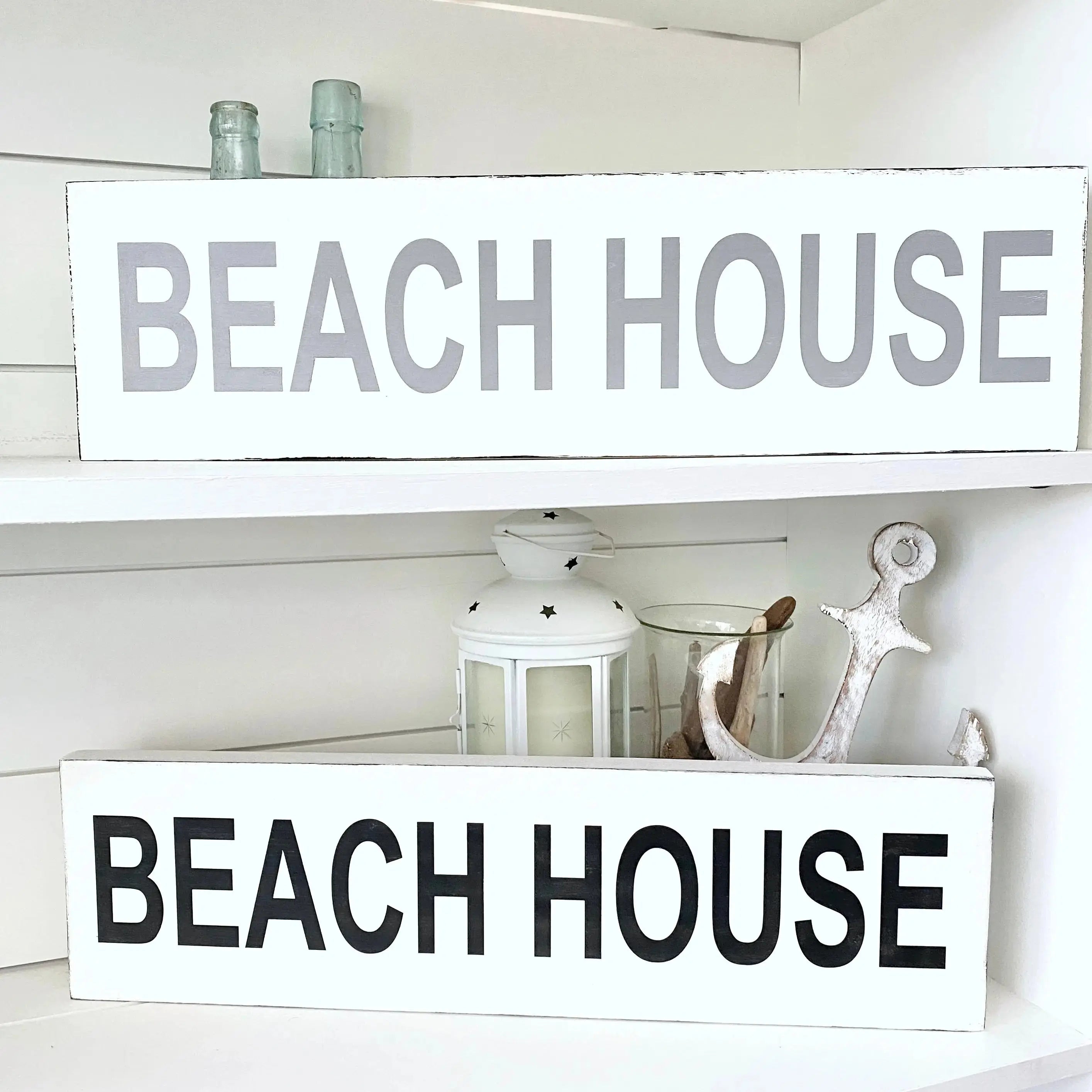 handmade coastal wood sign displayed on wall with beach decor