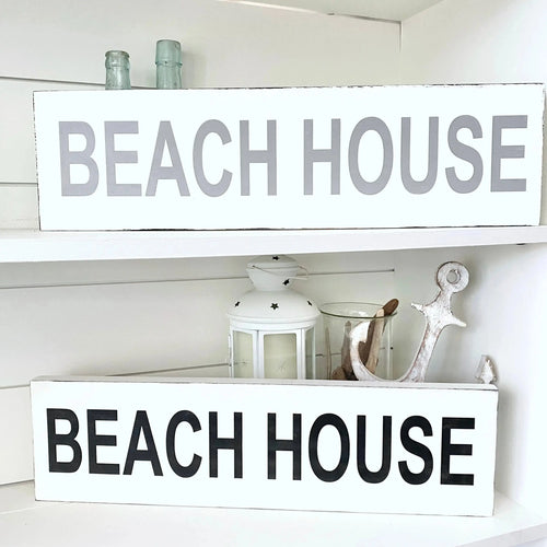 handmade coastal wood sign displayed on wall with beach decor