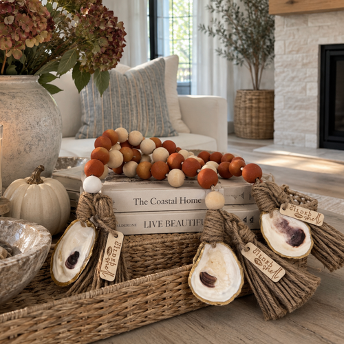 Coastal fall oyster shell garland with natural rope tassels and warm neutral pom-pom accents