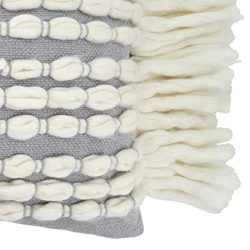 Cozy coastal lumbar pillow with thick cream yarn loops and fringe, ideal for beach house lounging.