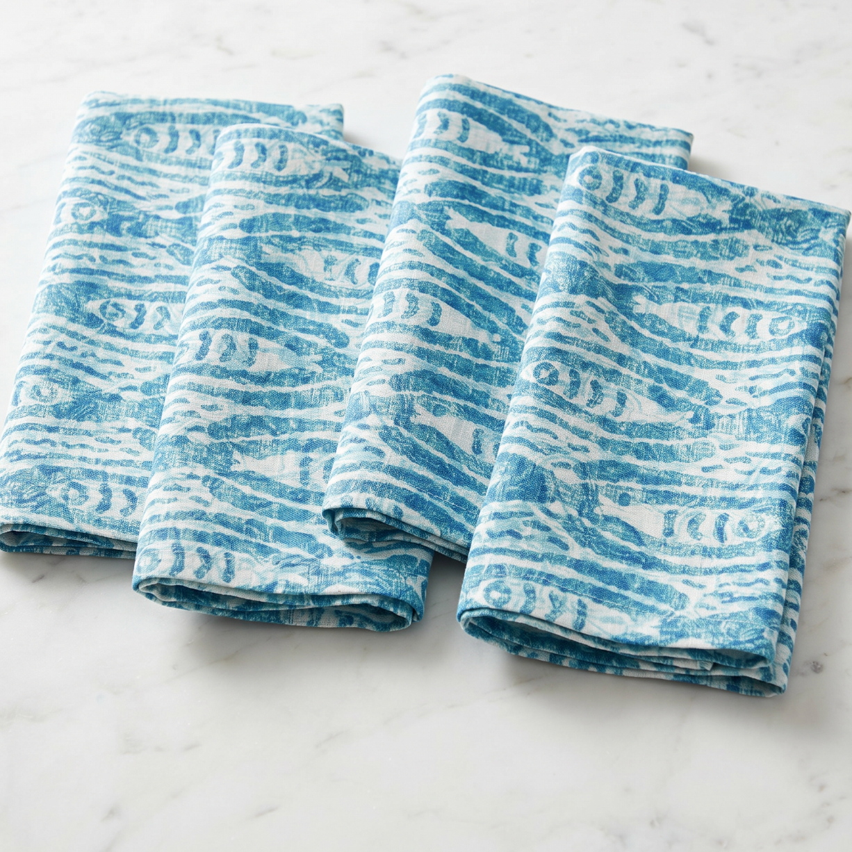 Fish print linen cloth napkins set of four styled for a beach house table setting