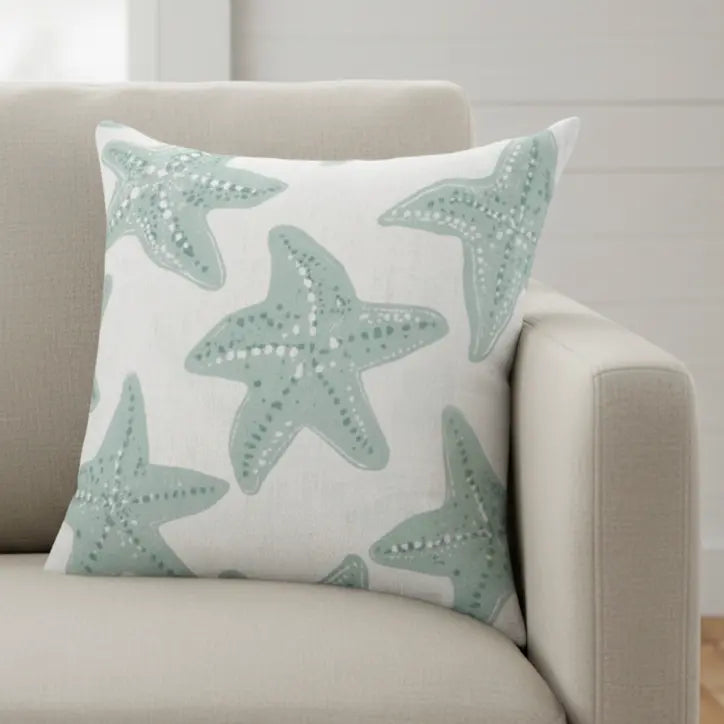 Starfish Coastal Throw Pillow with teal starfish motif on white fabric for coastal, neutral decor.
