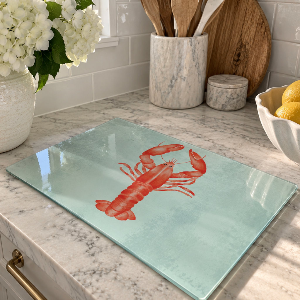 Coastal glass serving board with a decorative lobster pattern.