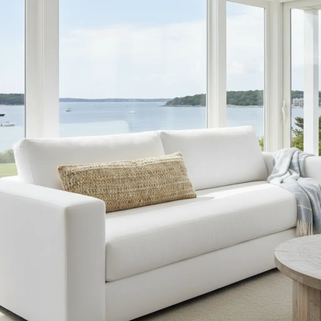 Cure Hand Crochet Large Lumbar Pillow on white sofa with a natural beige woven cover.