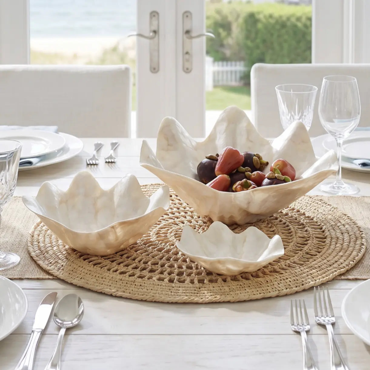 Coastal mother of pearl clam shell bowl trio displayed as a luxe centerpiece