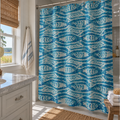 Nautical blue fish shower curtain styled in a beach-inspired bathroom