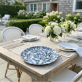 Oyster Serving Tray with a blue shell pattern on an outdoor dining table, surrounded by white hydrangea centerpieces.