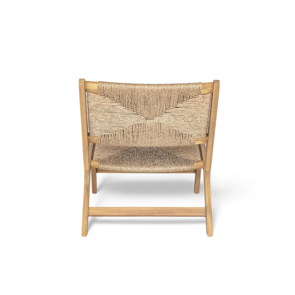 Modern acacia wicker lounge chair on sunlit porch with coffee table