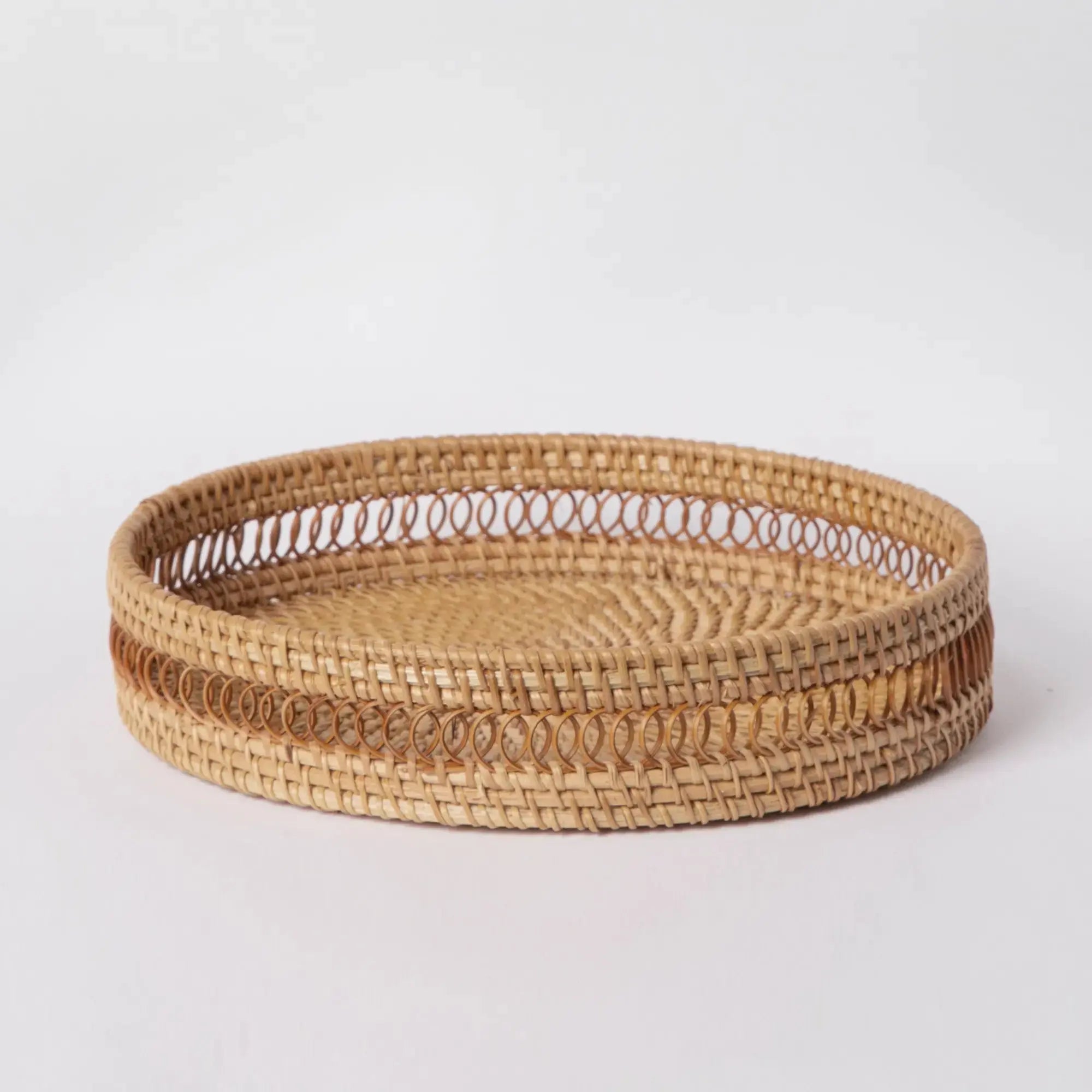 Handwoven rattan decorative tray displayed in a coastal living room