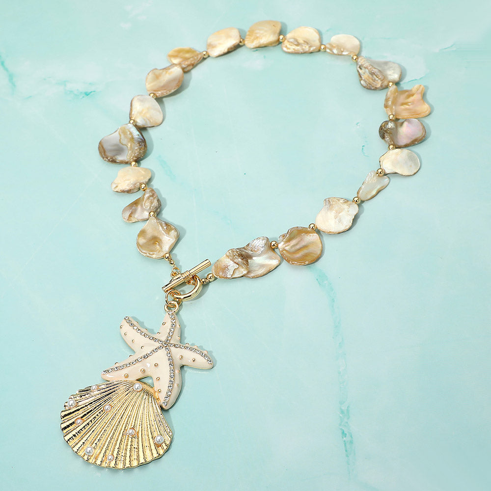 Rhinestone embellished starfish and pearl seashell pendant shell beaded statement necklace in coastal beach glam style
