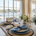 Set of 4 sailboat napkin rings holding linen napkins on a nautical coastal dining table
