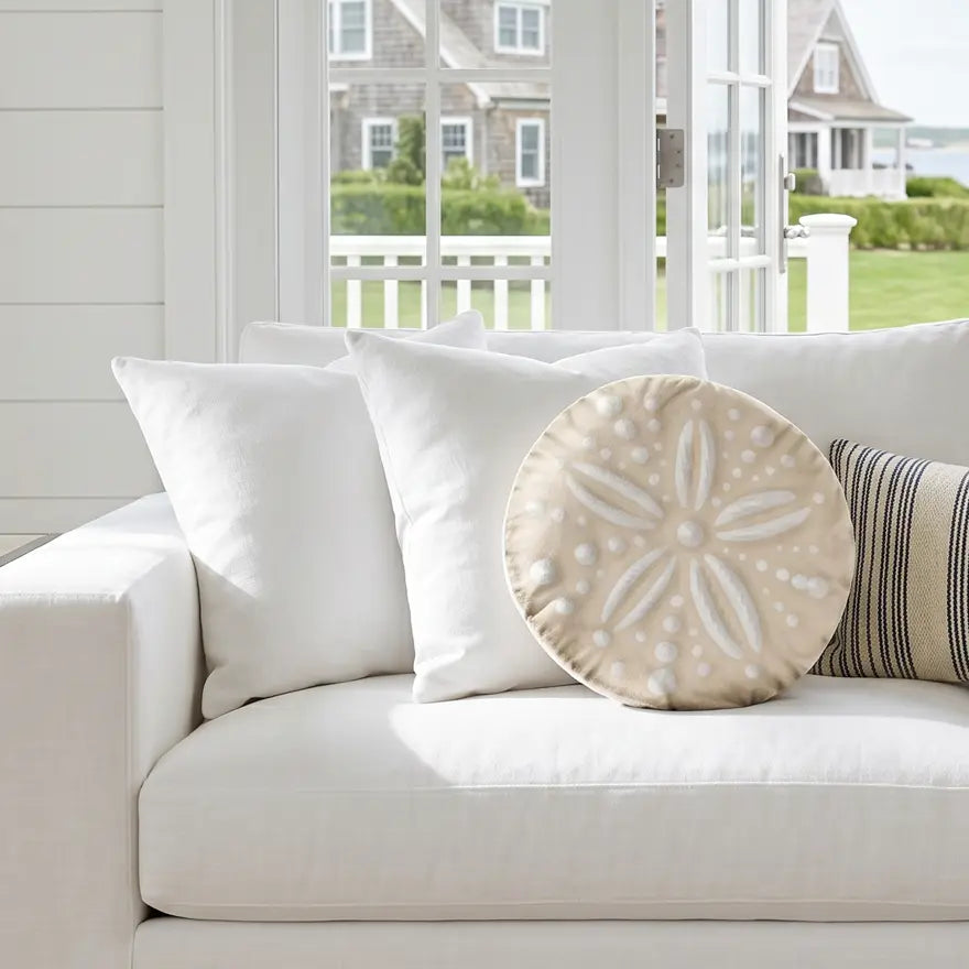 Coastal sand dollar pillow styled on a beach house sofa