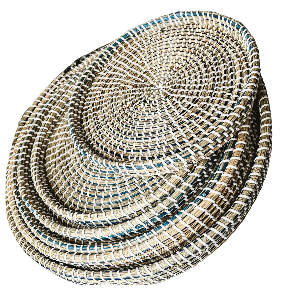 Set of 6 handwoven seagrass trays displayed in beach house living room