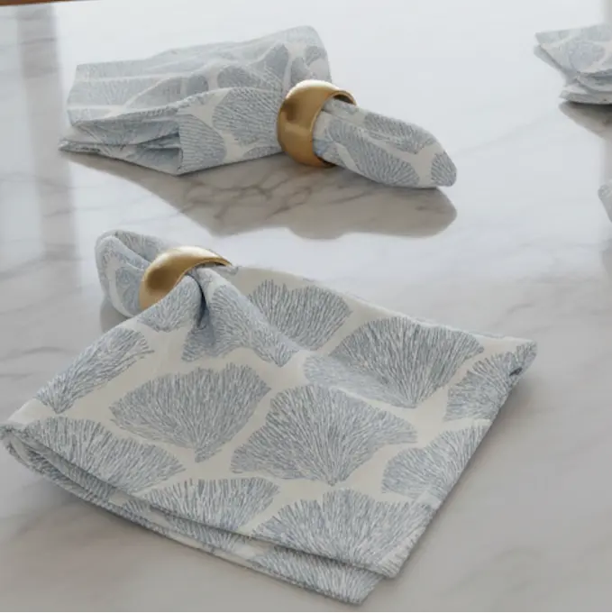Bar Harbor Coral Linen Napkins Set of 4 in sea-spray blue seashell pattern on white linen.